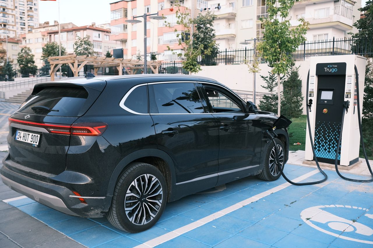 Electric car charging at a station. Clean energy.
